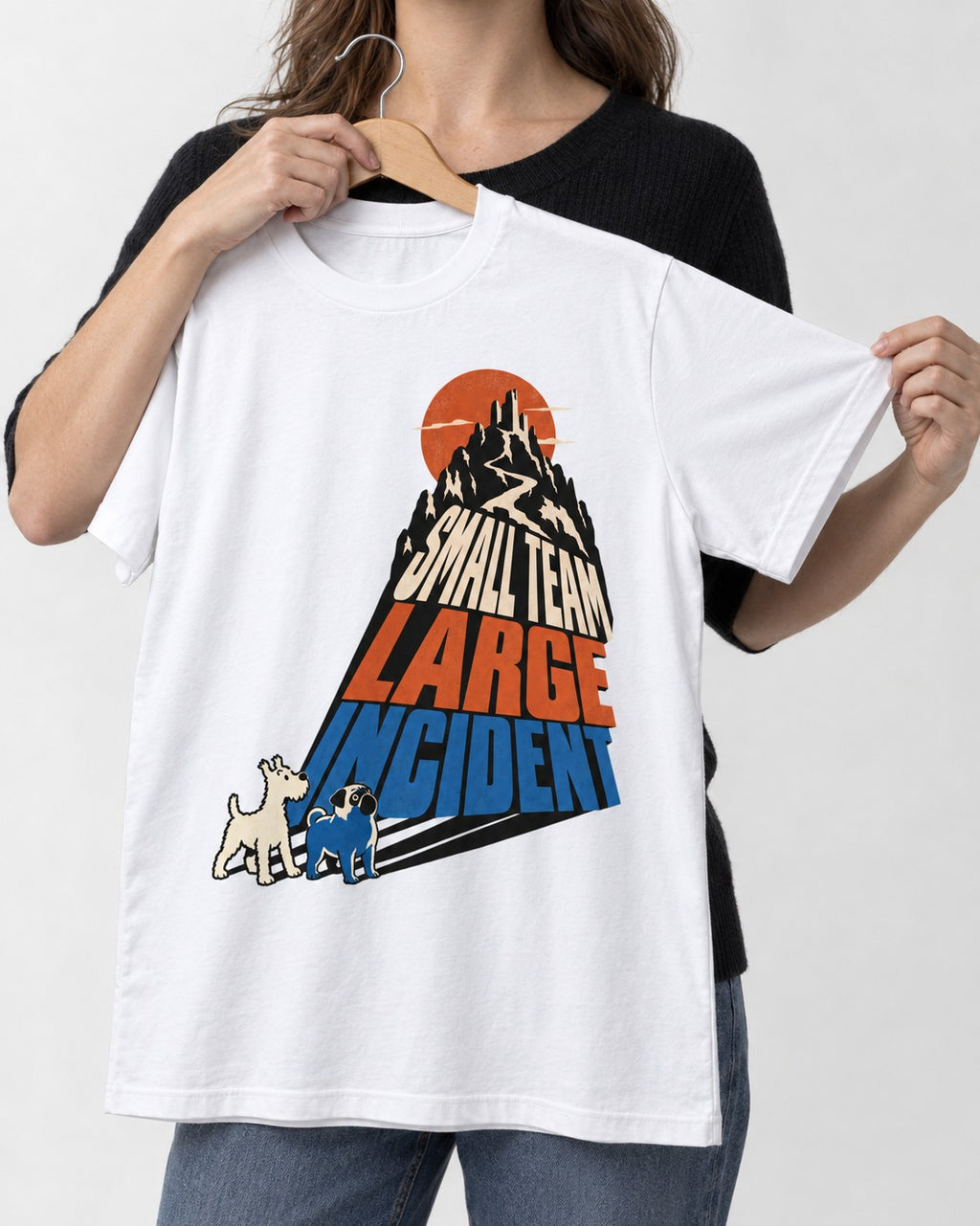 Pug Small Team Large Incident Mountain Graphic T-Shirt in White, held up on a hanger