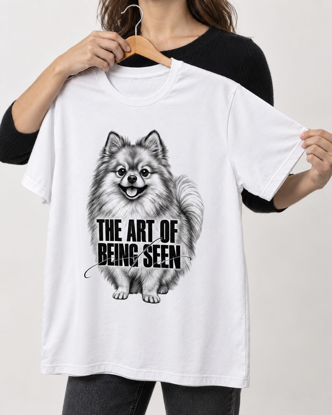 Pomeranian The Art of Being Seen Portrait Graphic T-Shirt in White, held up on a hanger