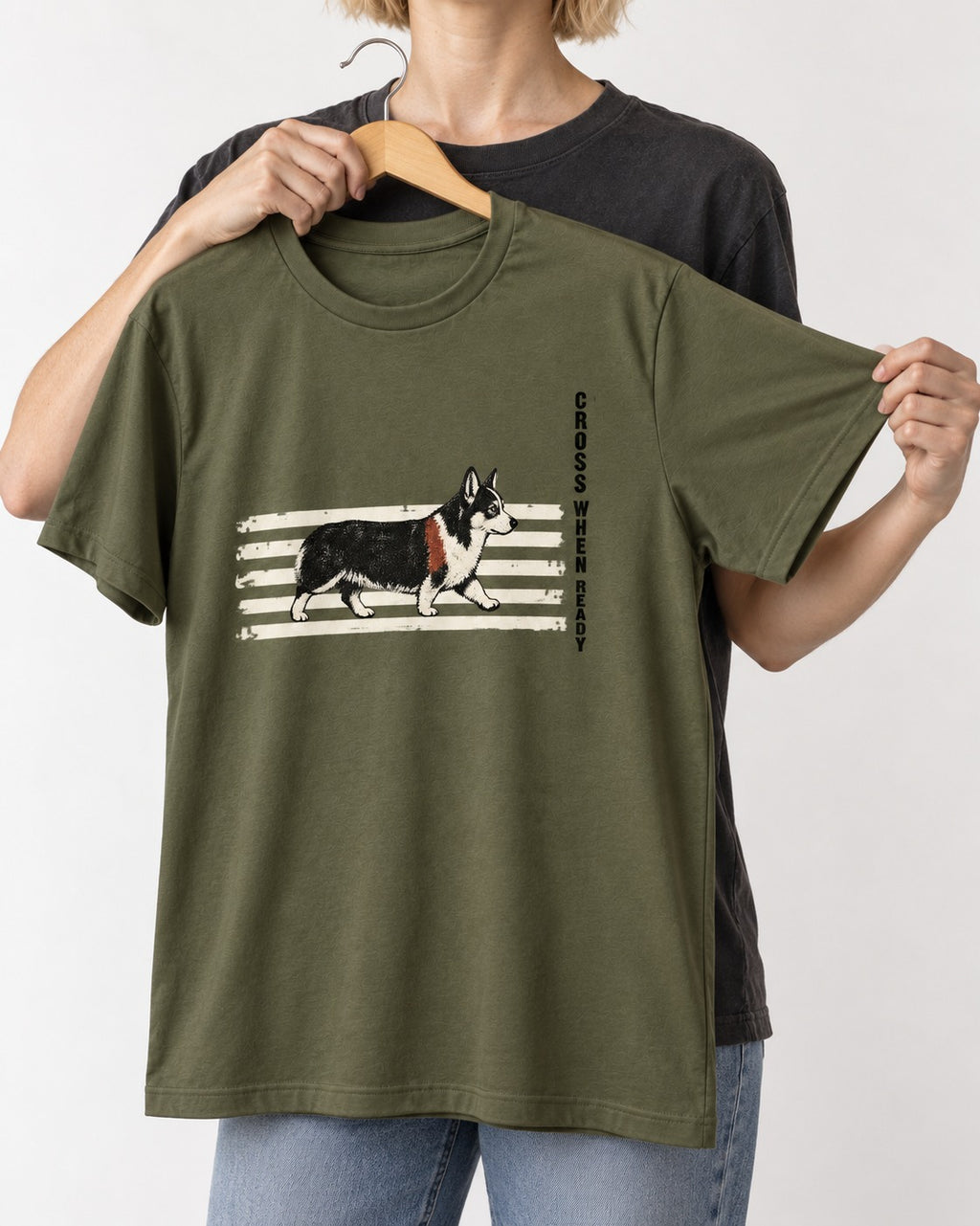 Corgi Cross When Ready Crossing Bars Graphic T-Shirt in Heather Military Green, held up on a hanger