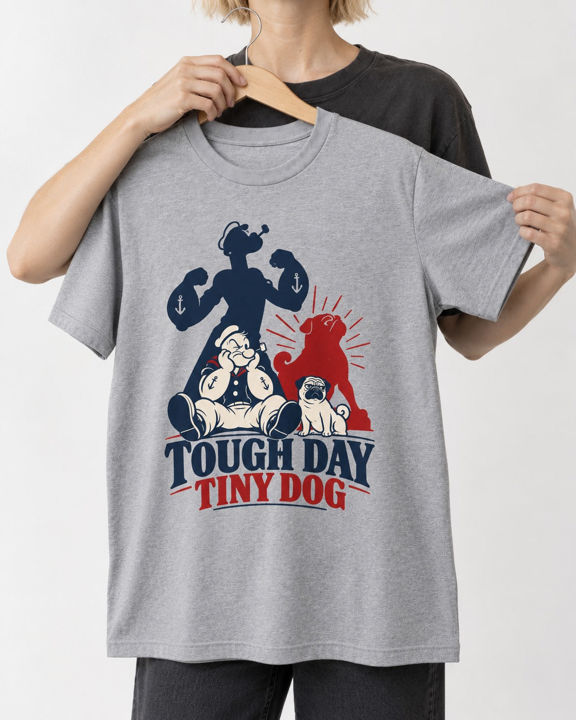 Tough Day Tiny Pug T-Shirt in Sport Grey, held up on a hanger