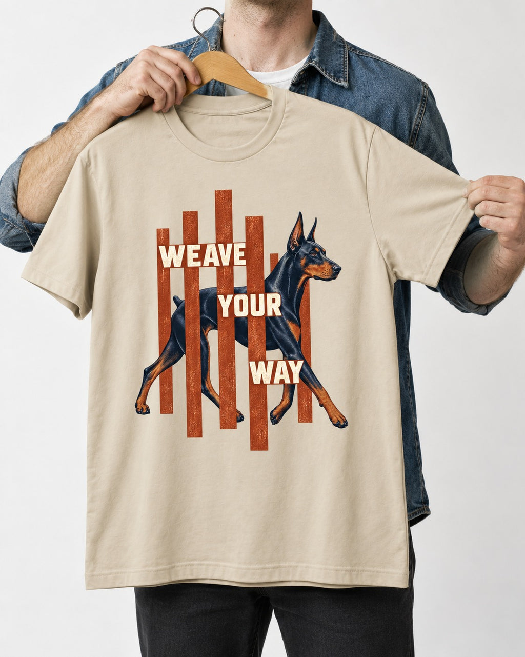 Weave Your Way Doberman T-Shirt in Sand, held up on a hanger