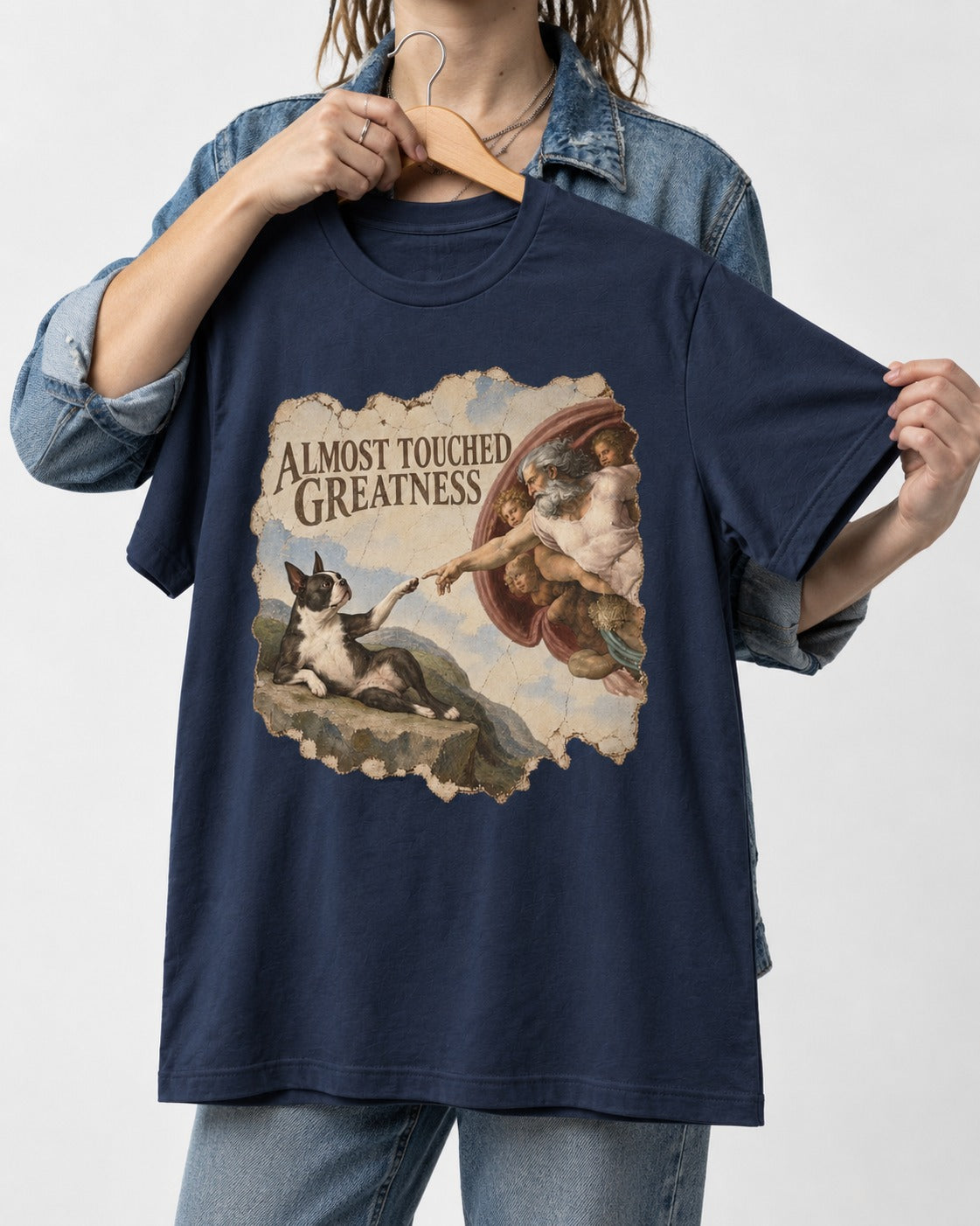 Almost Touched Greatness Boston Terrier Renaissance Parody T-Shirt in Navy, held up on a hanger