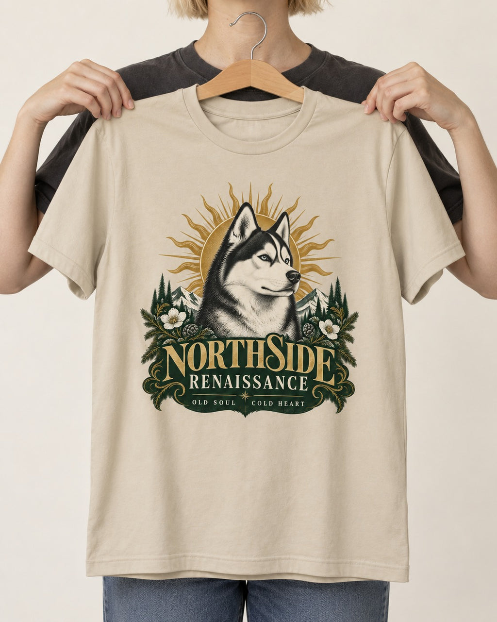 Northside Renaissance Husky T-Shirt in Sand, held up on a hanger