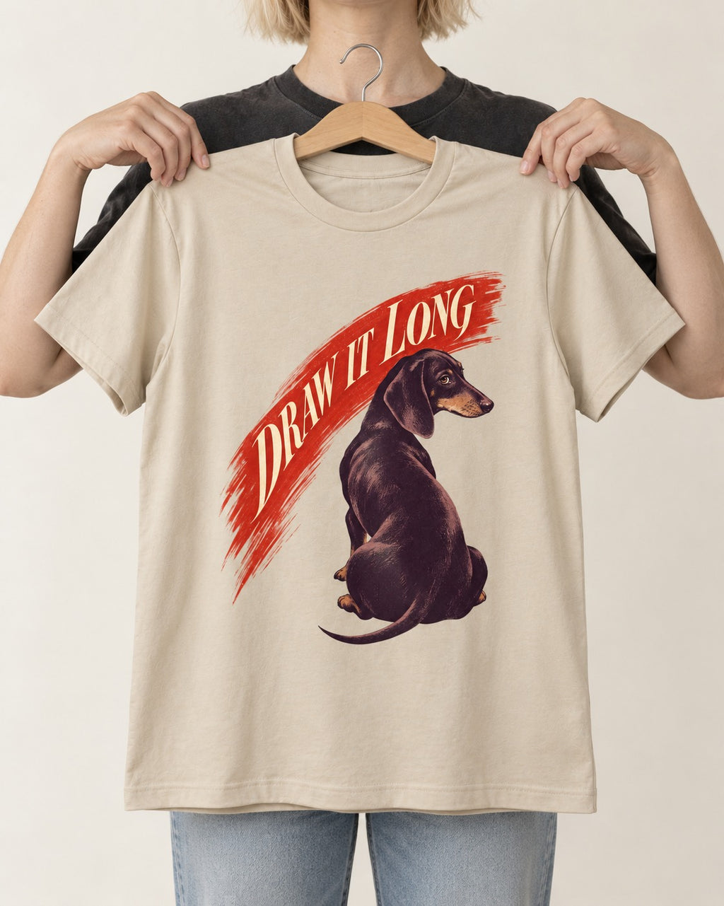 Draw It Long Dachshund T-Shirt in Sand, held up on a hanger