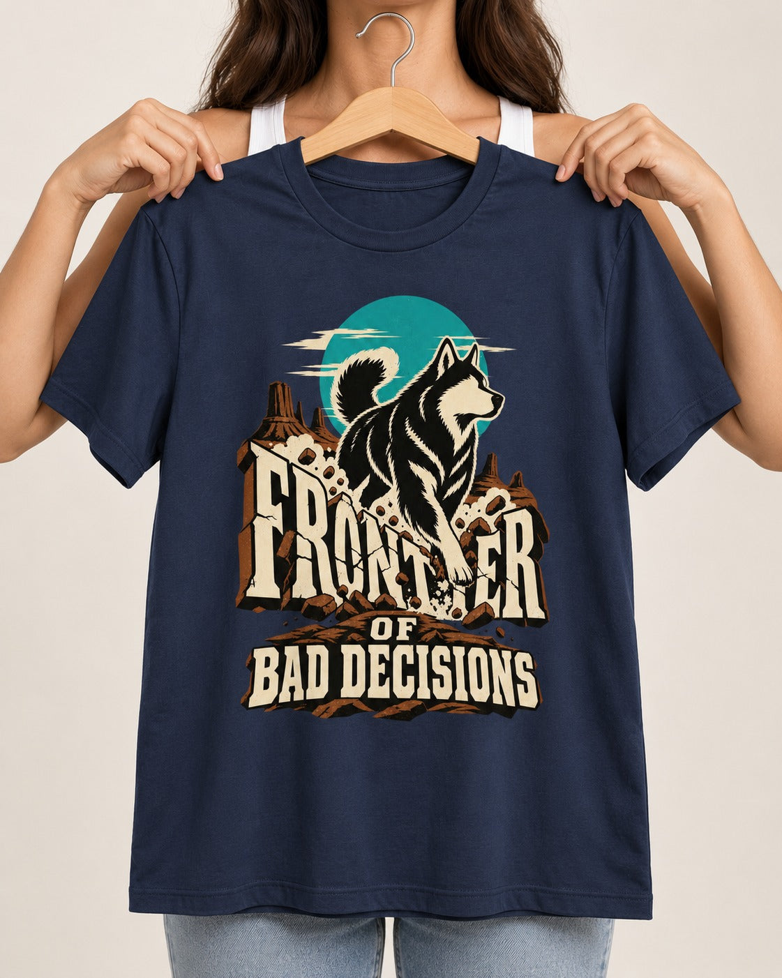 Husky Frontier of Bad Decisions Desert Graphic T-Shirt in Navy, held up on a hanger