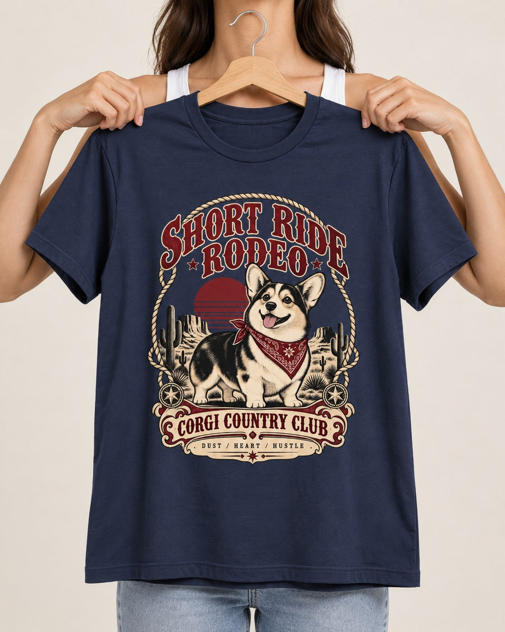 Corgi Short Ride Rodeo Country Club Badge T-Shirt in Navy, held up on a hanger