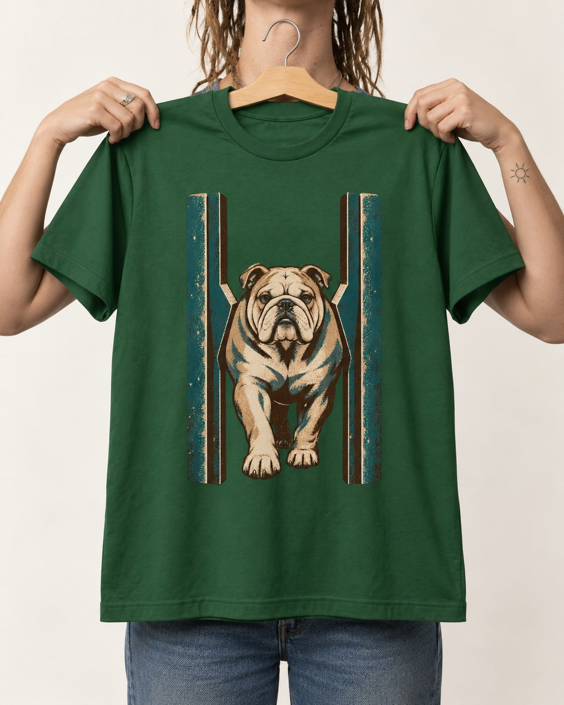 English Bulldog Walking Through Teal Gate Graphic T-Shirt in Forest Green, held up on a hanger
