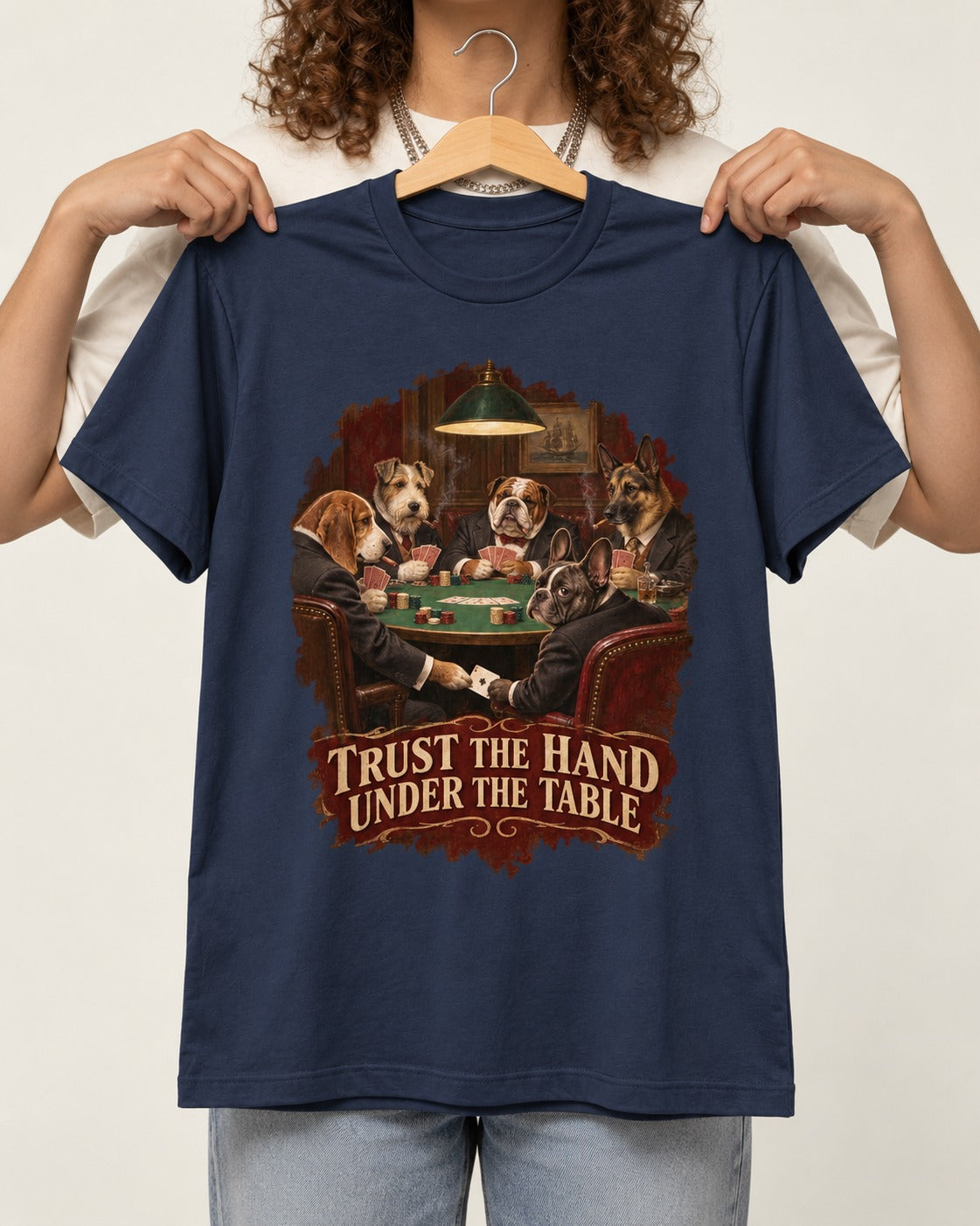 Frenchie Trust the Hand Under the Table Poker Dogs Graphic T-Shirt in Navy, held up on a hanger