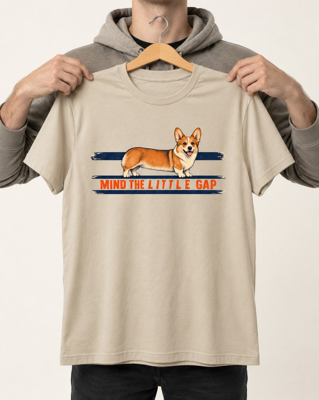 Mind the Little Corgi Gap T-Shirt in Sand, held up on a hanger