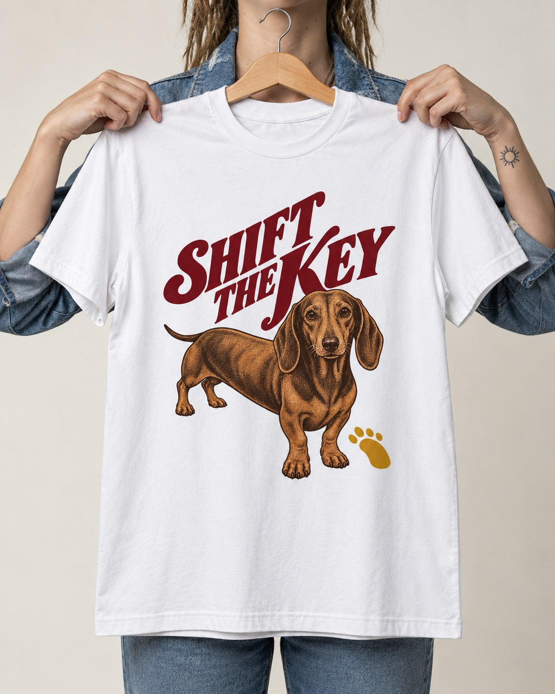 Dachshund Shift The Key Pawprint Graphic T-Shirt in White, held up on a hanger