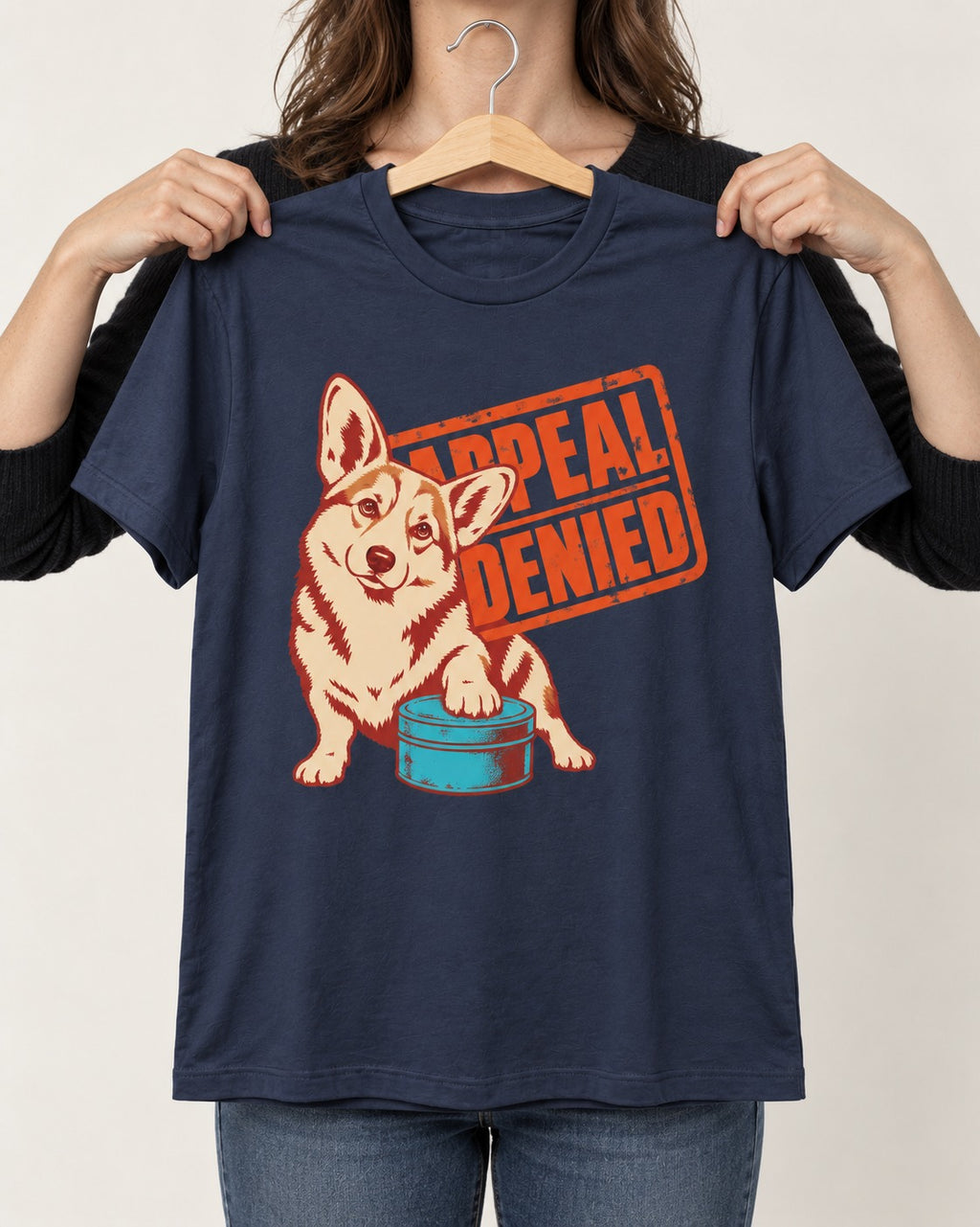 Corgi Appeal Denied Treat Tin T-Shirt in Navy, held up on a hanger