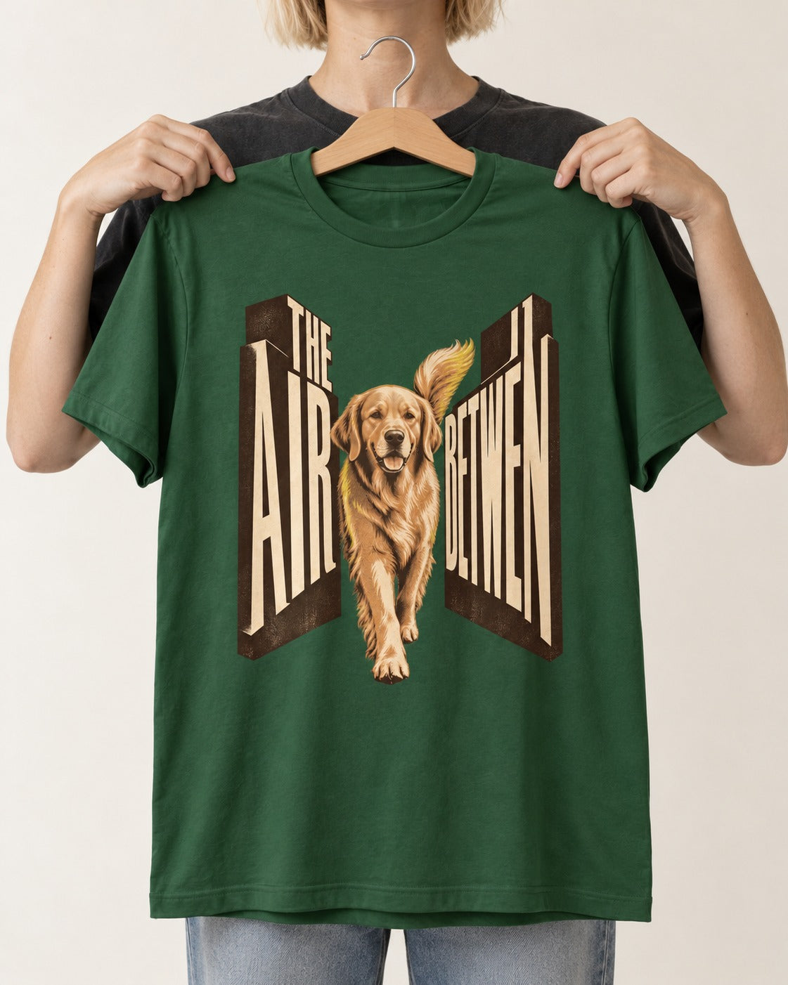 The Air Between Dimensional Golden Retriever Graphic T-Shirt in Forest Green, held up on a hanger