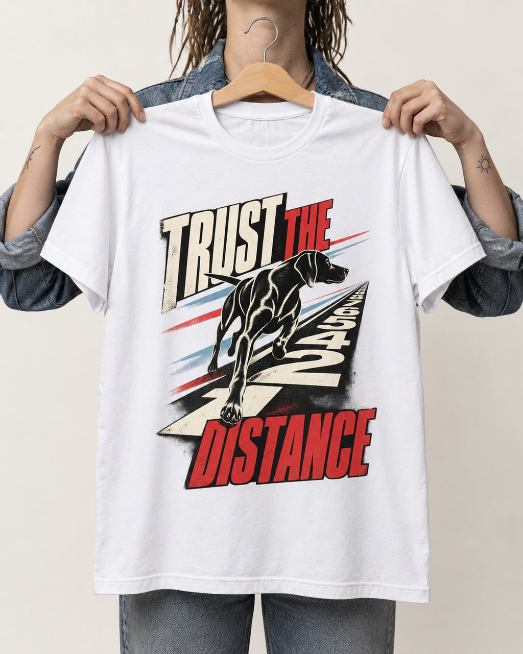 Trust the Distance German Shorthaired Pointer Graphic T-Shirt in White, held up on a hanger