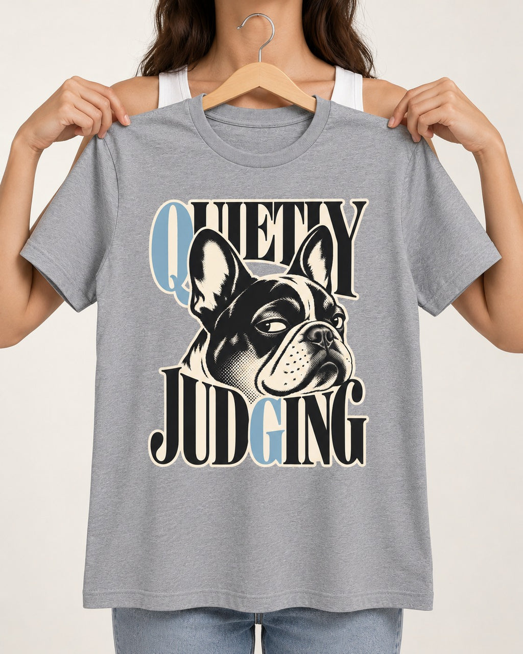 Quietly Judging Frenchie T-Shirt in Sport Grey, held up on a hanger