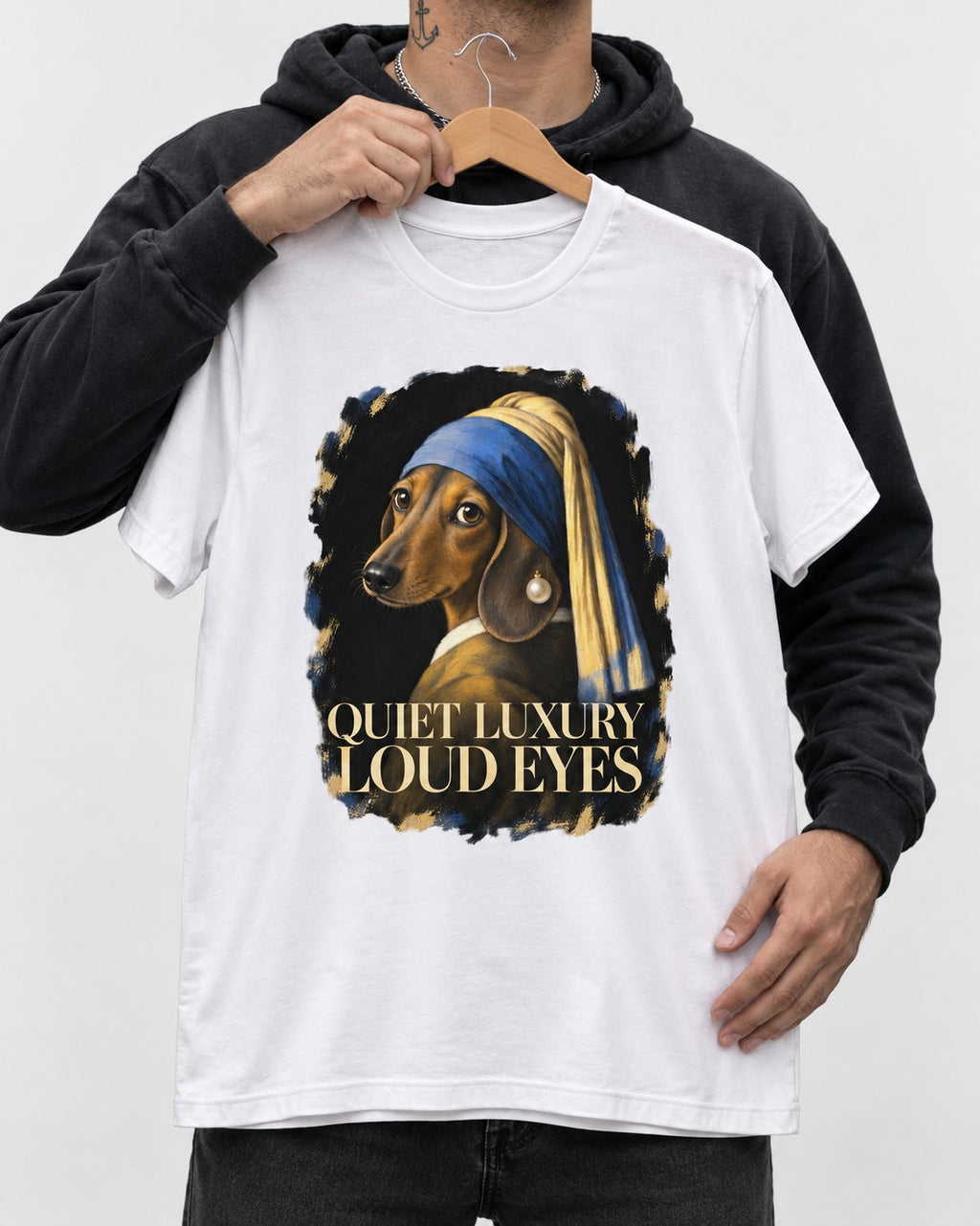 Dachshund Quiet Luxury Loud Eyes Pearl Portrait Graphic T-Shirt in White, held up on a hanger