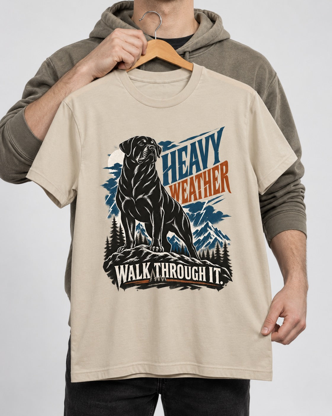 Heavy Weather Rottweiler T-Shirt in Sand, held up on a hanger