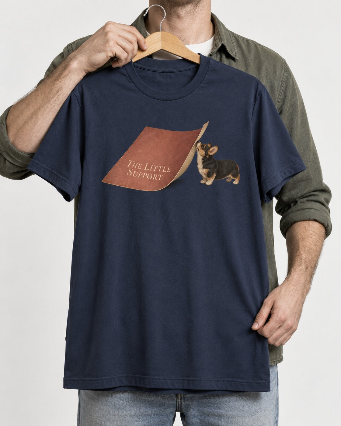 Corgi The Little Support Paper Graphic T-Shirt in Navy, held up on a hanger