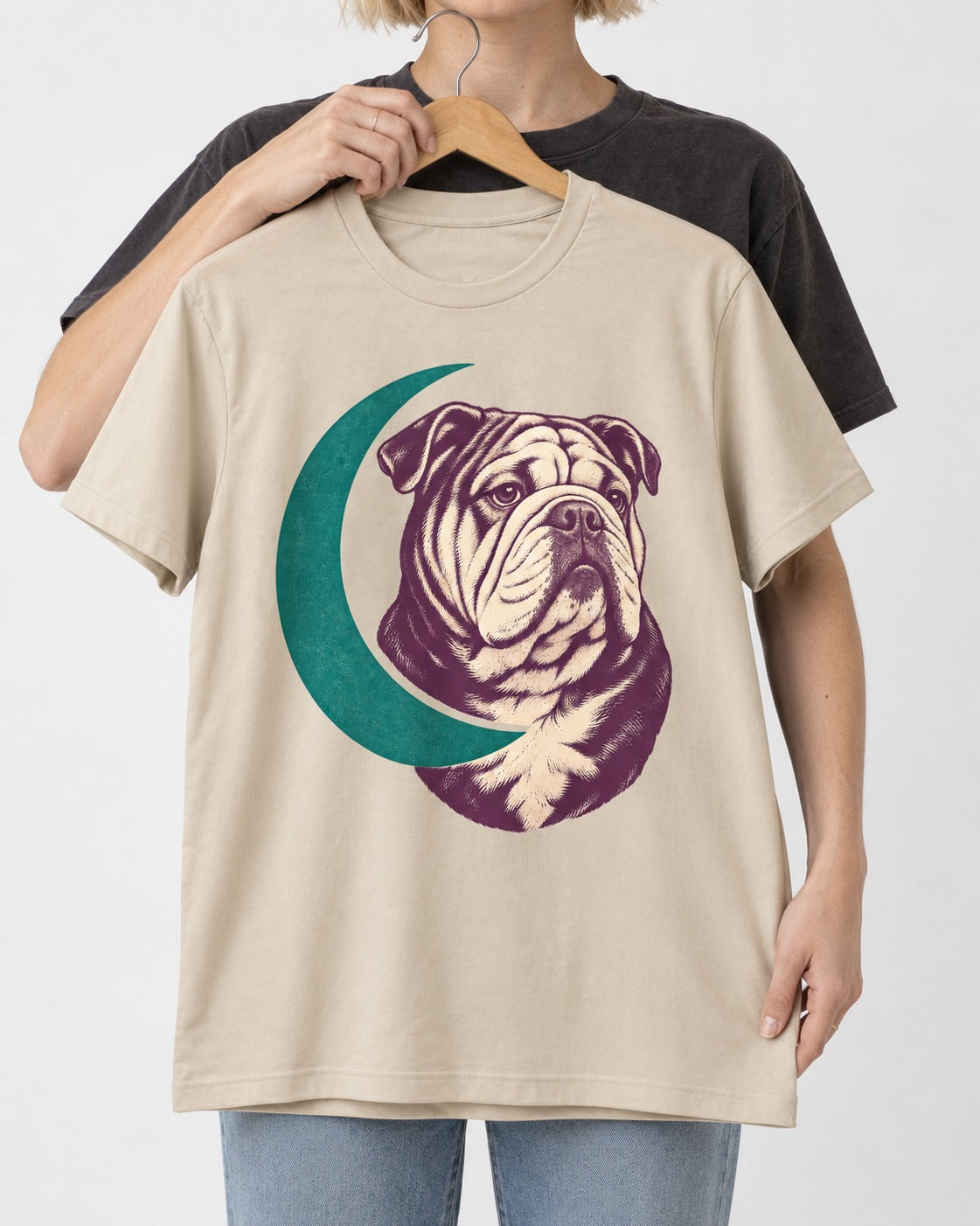 Moonstruck English Bulldog T-Shirt in Sand, held up on a hanger