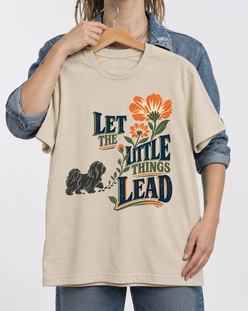 Let the Shih Tzu Lead T-Shirt in Sand, held up on a hanger