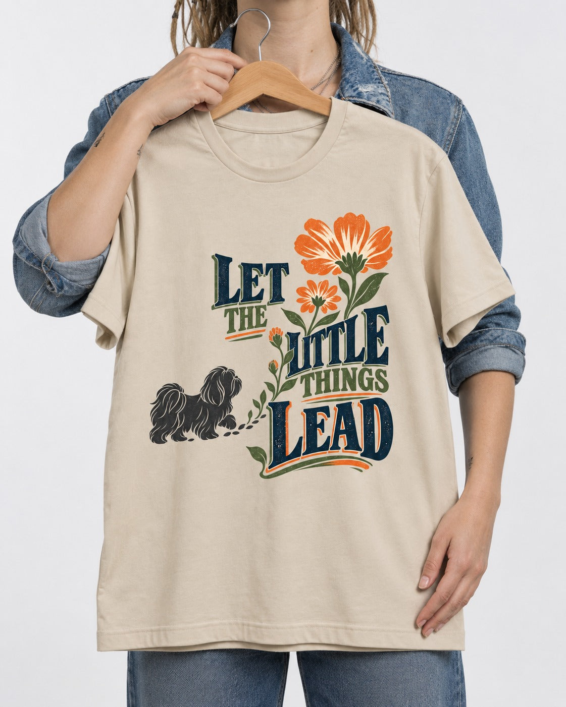 Let the Shih Tzu Lead T-Shirt in Sand, held up on a hanger