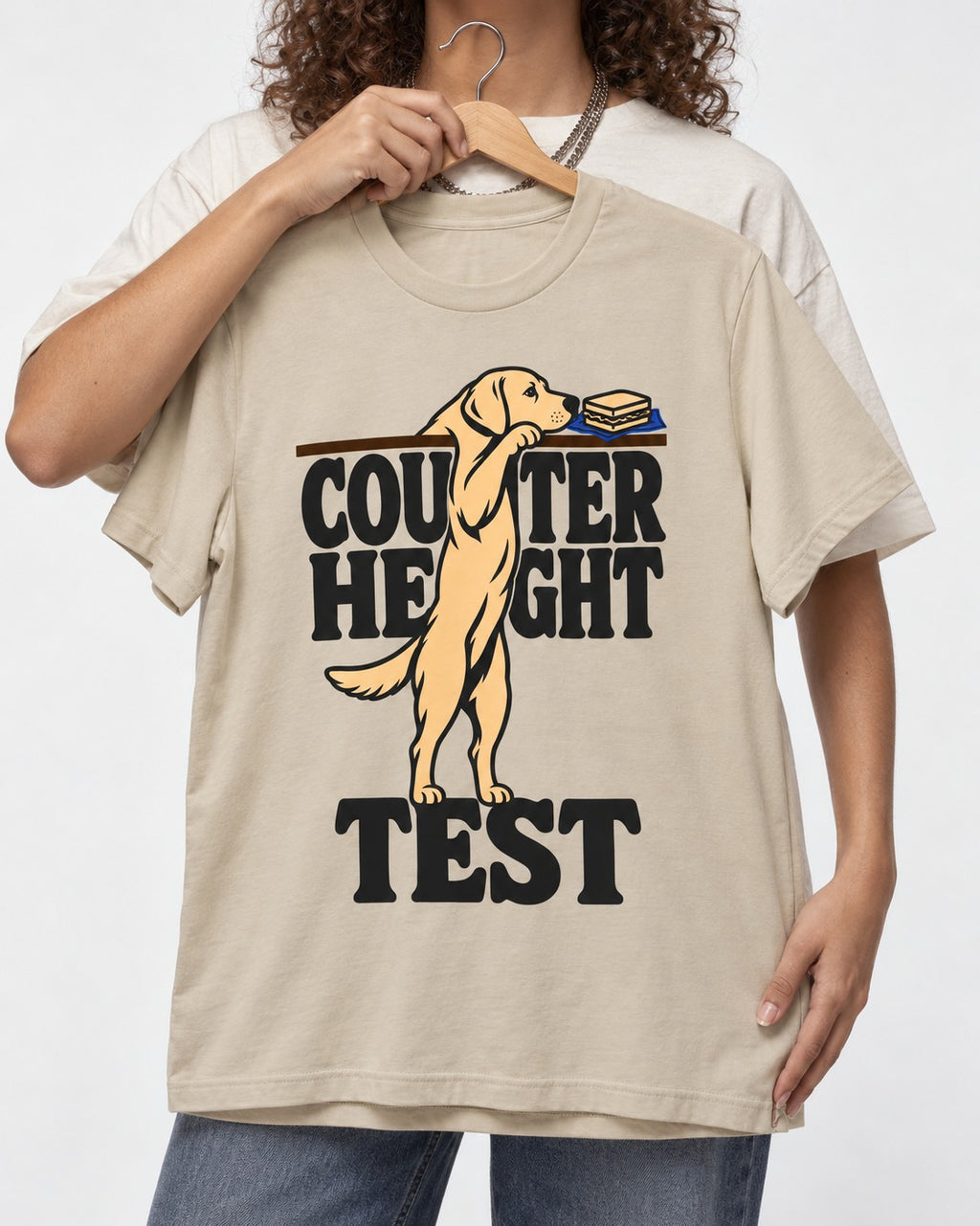 Labrador Retriever Counter Height Test T-Shirt in Sand, held up on a hanger