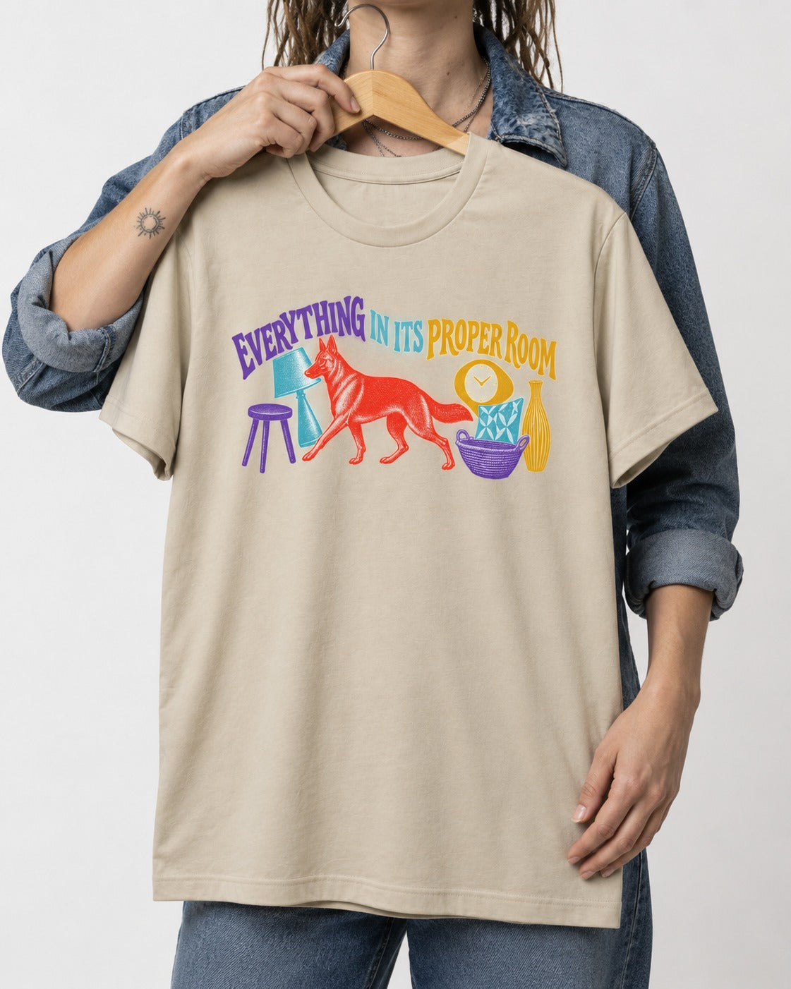 German Shepherd Dog In Its Proper Room T-Shirt in Sand, held up on a hanger