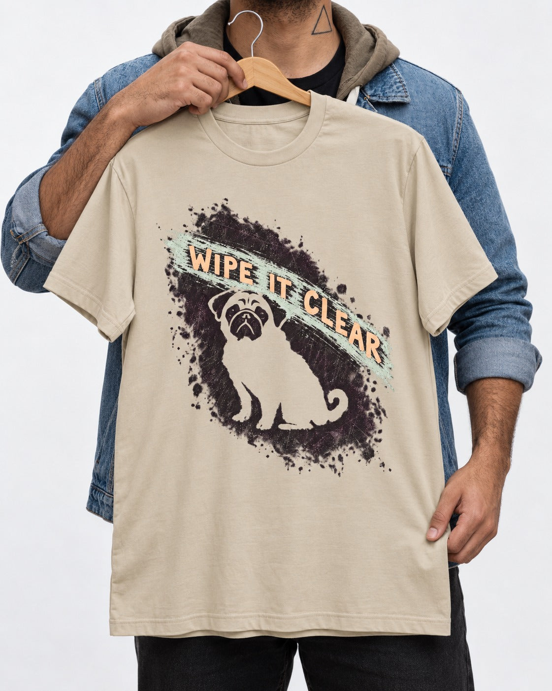 Pug Wipe It Clear T-Shirt in Sand, held up on a hanger