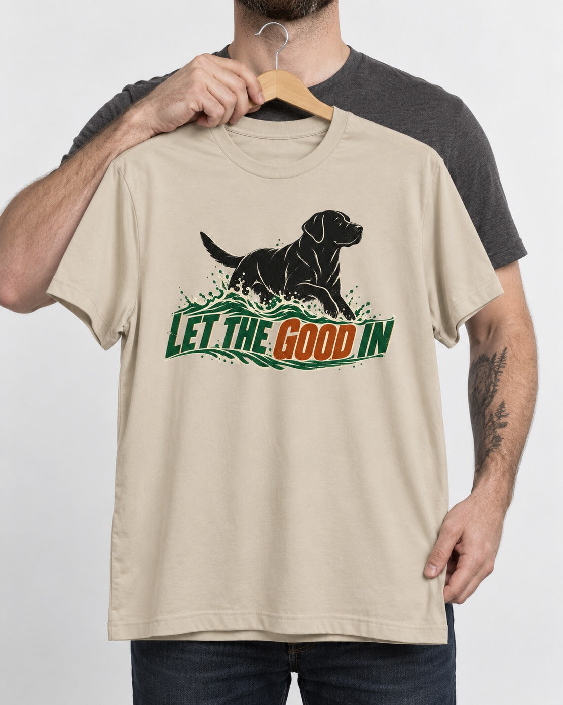 Labrador Retriever Let the Good In T-Shirt in Sand, held up on a hanger