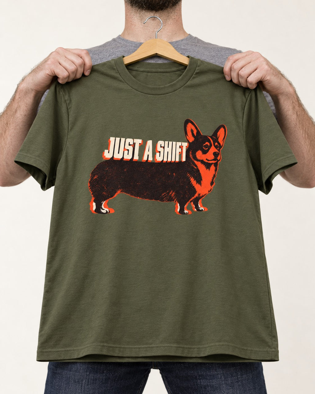 Corgi Just a Shift Typographic Graphic T-Shirt in Heather Military Green, held up on a hanger