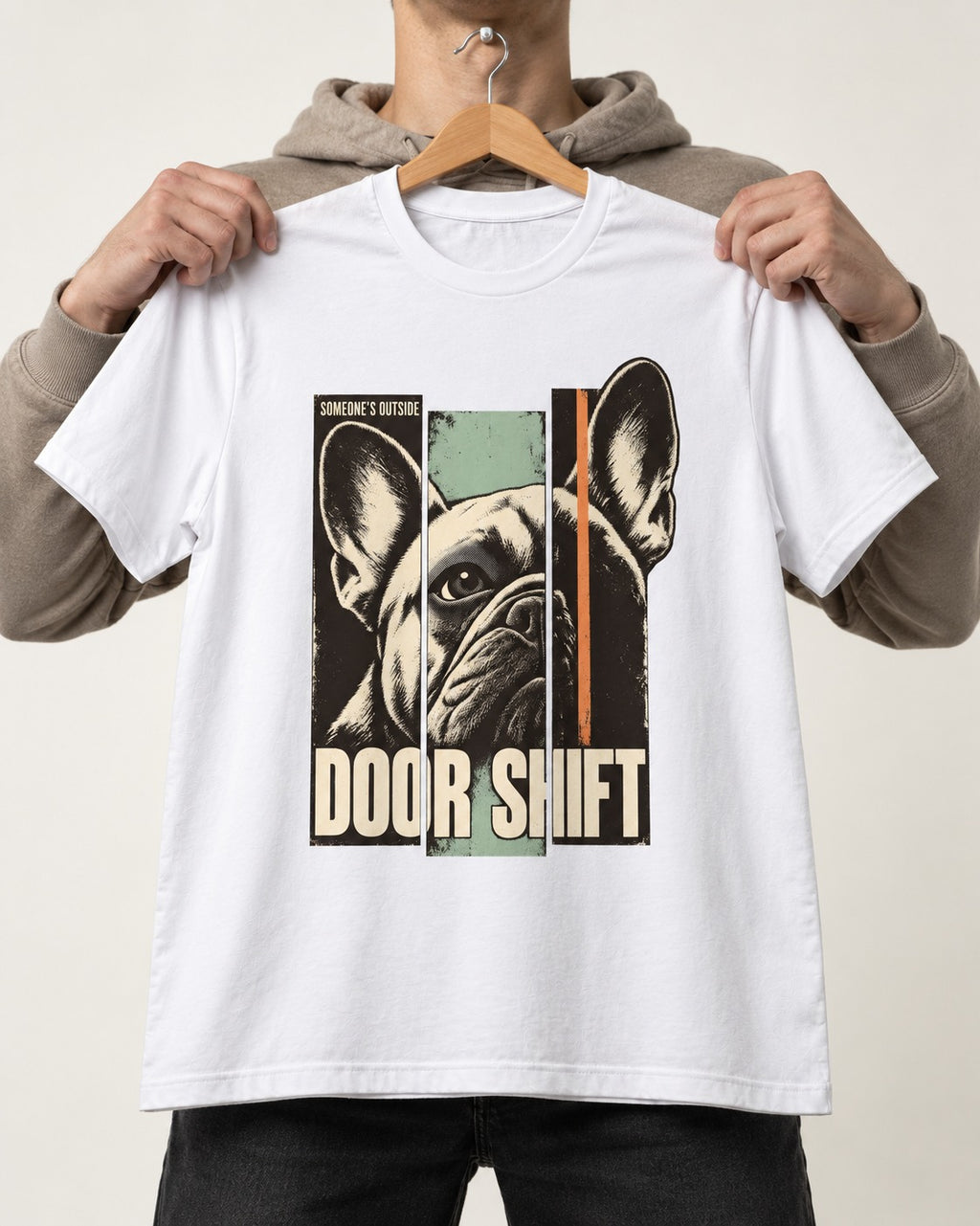 Frenchie Someone's Outside Door Shift Graphic T-Shirt in White, held up on a hanger