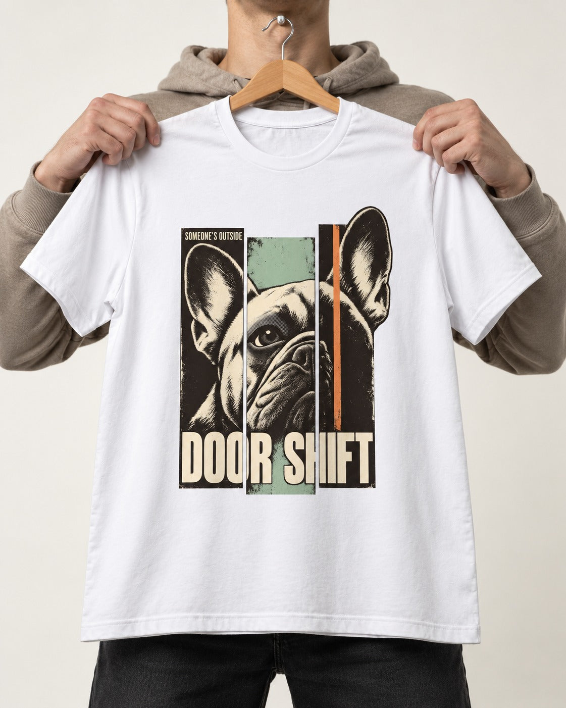 Frenchie Someone's Outside Door Shift Graphic T-Shirt in White, held up on a hanger