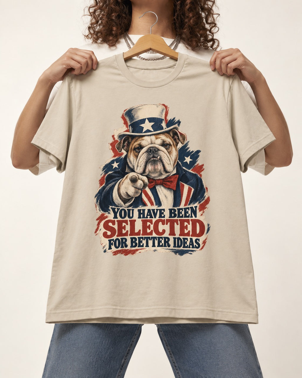 English Bulldog Selected for Better Ideas T-Shirt in Sand, held up on a hanger