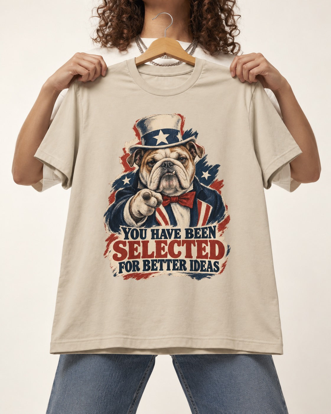 English Bulldog Selected for Better Ideas T-Shirt in Sand, held up on a hanger