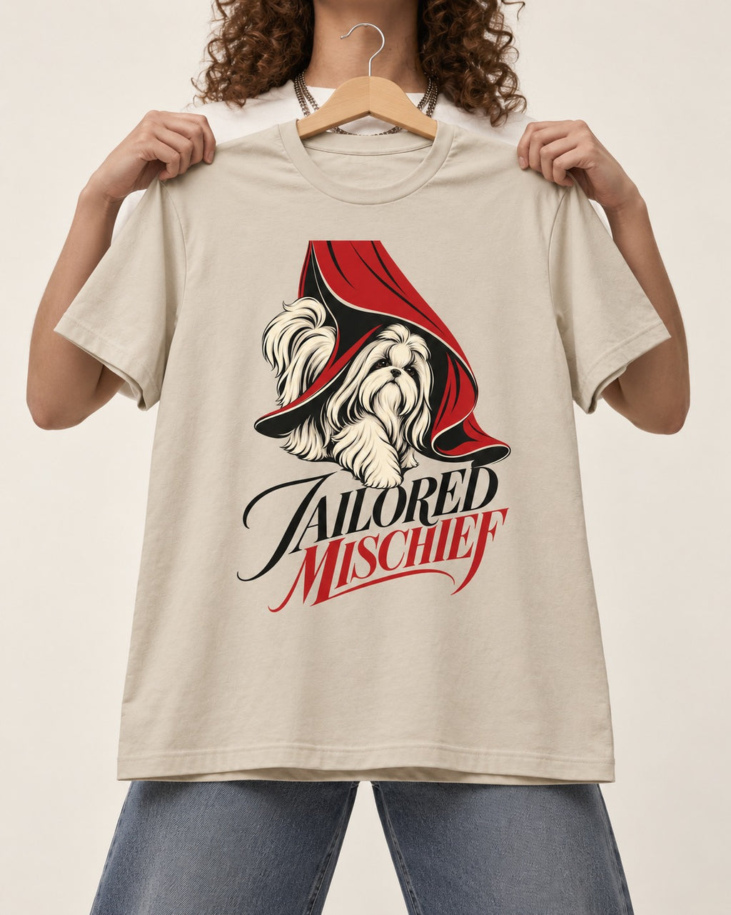 Tailored Mischief Shih Tzu T-Shirt in Sand, held up on a hanger