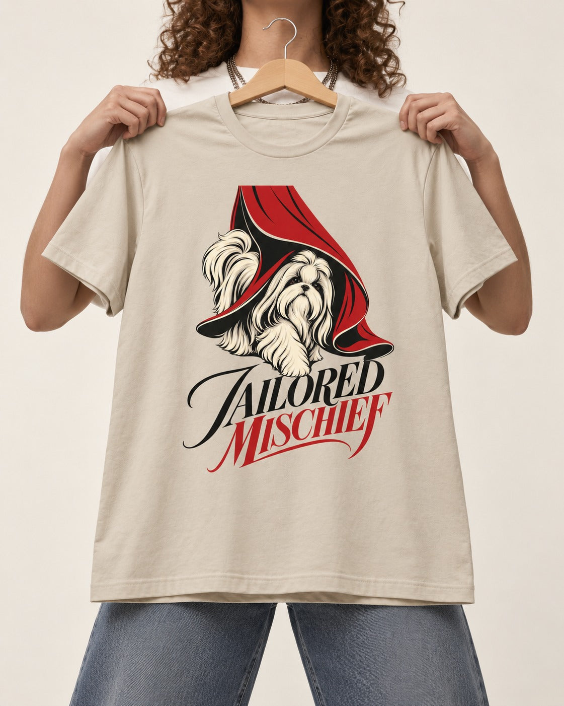 Tailored Mischief Shih Tzu T-Shirt in Sand, held up on a hanger