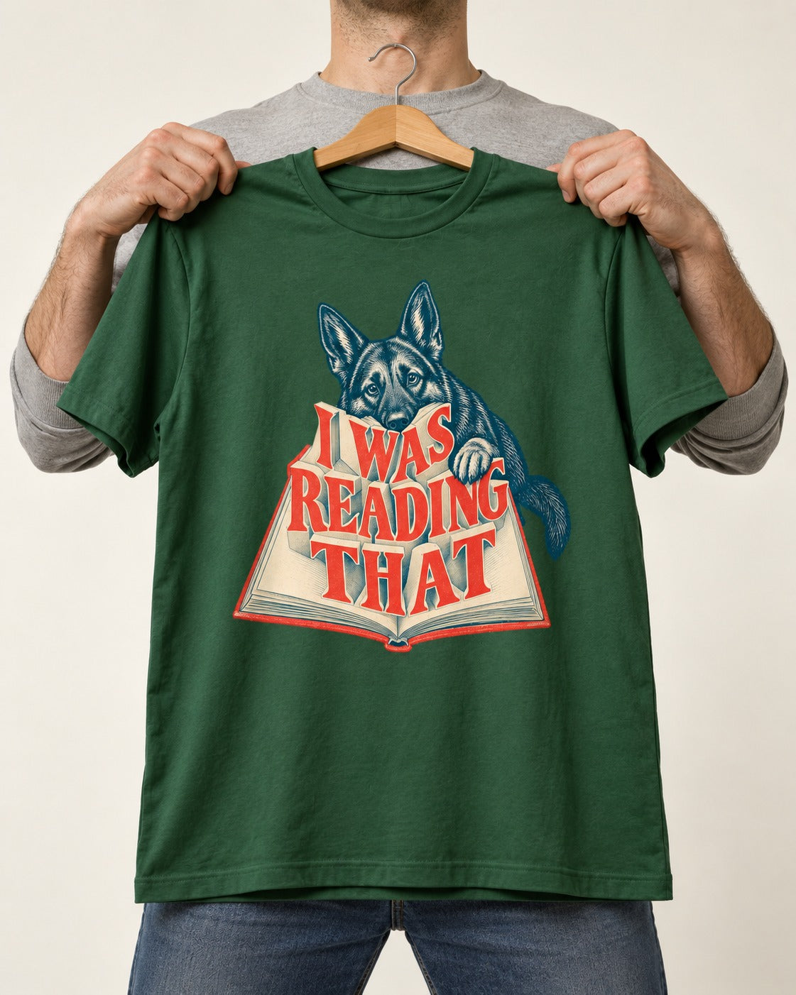German Shepherd Dog I Was Reading That Open Book Graphic T-Shirt in Forest Green, held up on a hanger