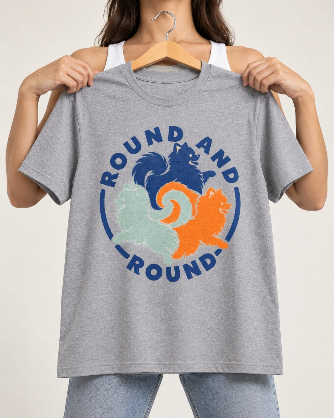Pomeranian Round and Round T-Shirt in Sport Grey, held up on a hanger