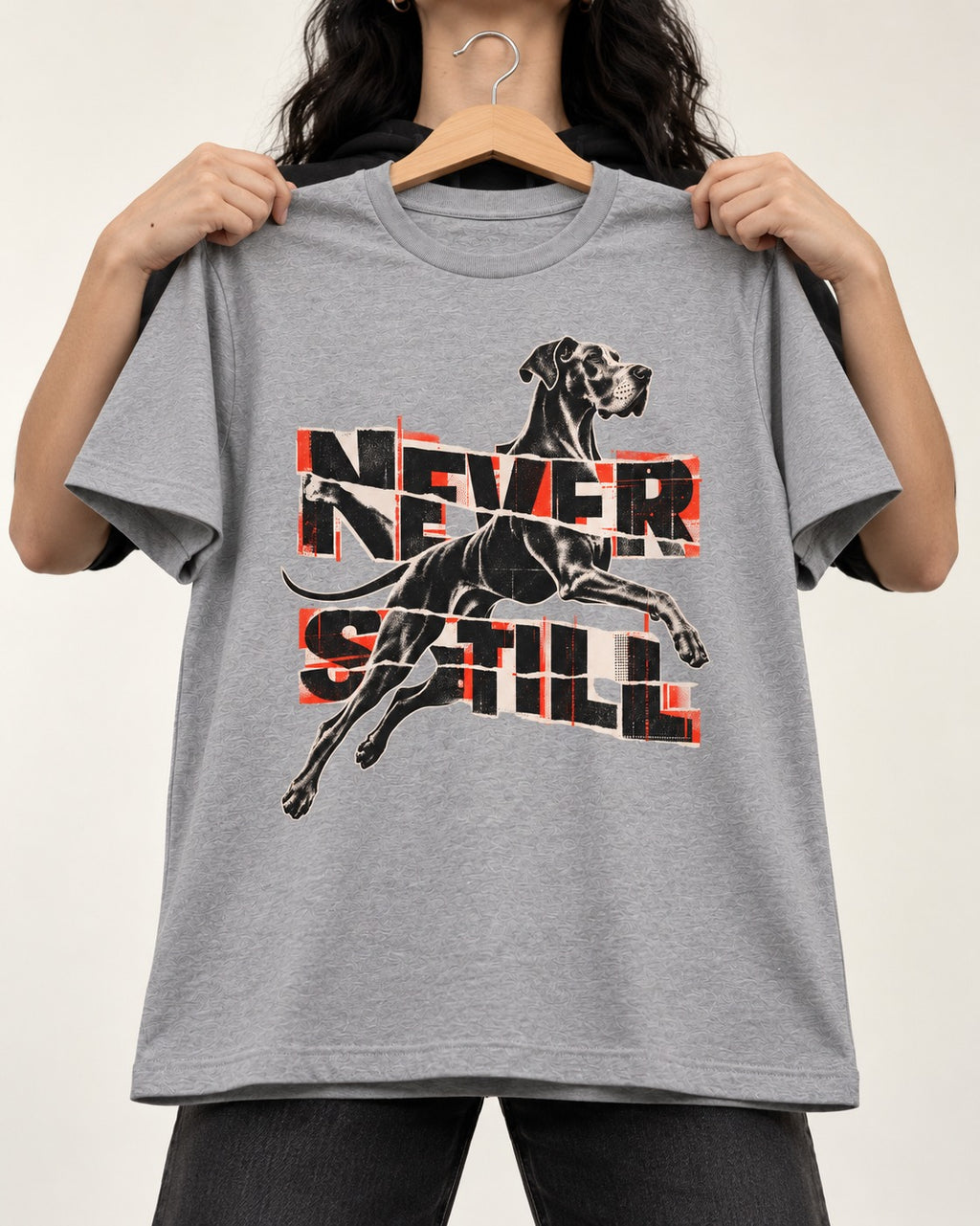 Great Dane Never Still Leaping Collage Graphic T-Shirt in Sport Grey, held up on a hanger