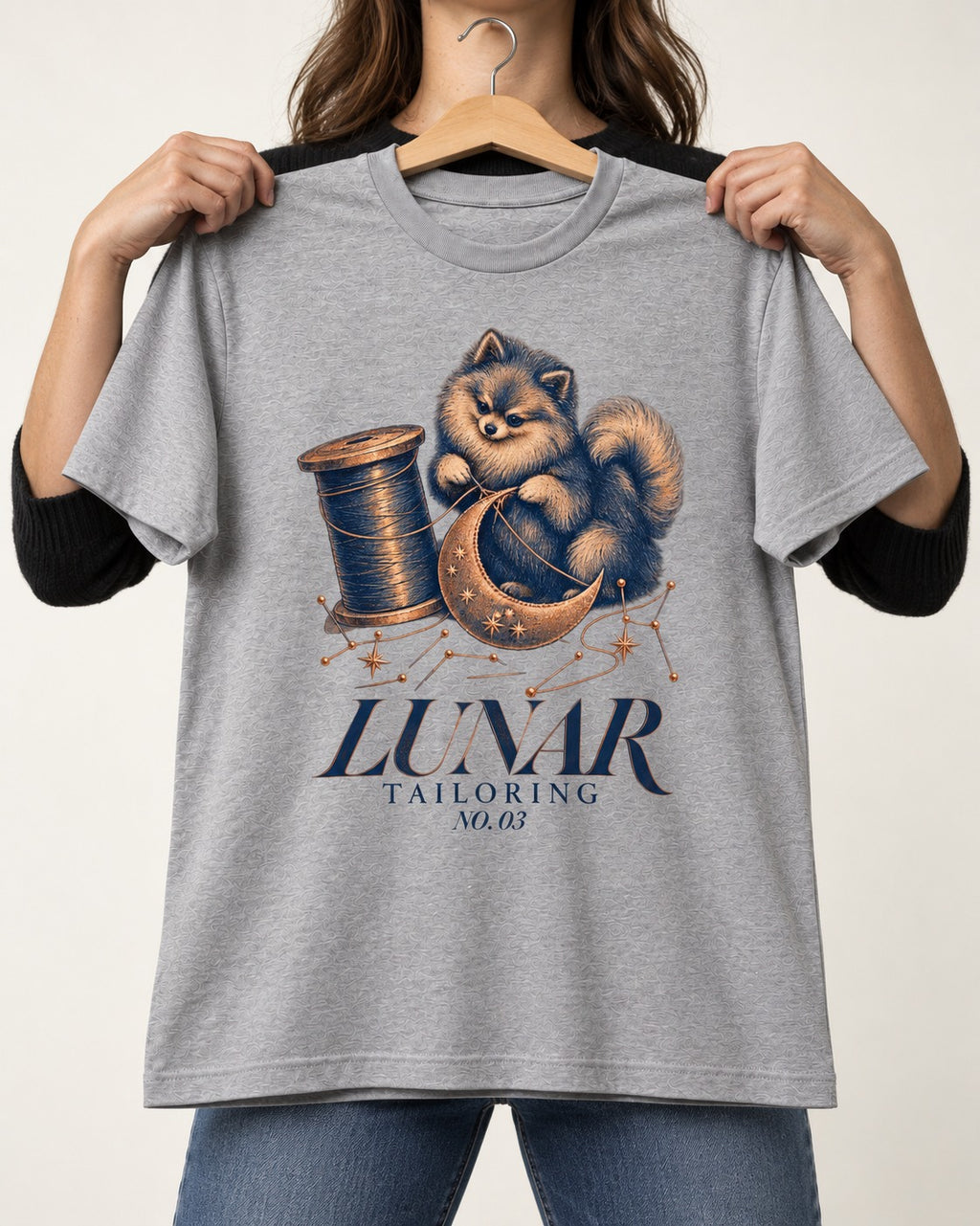 Pomeranian's Lunar Tailoring T-Shirt in Sport Grey, held up on a hanger