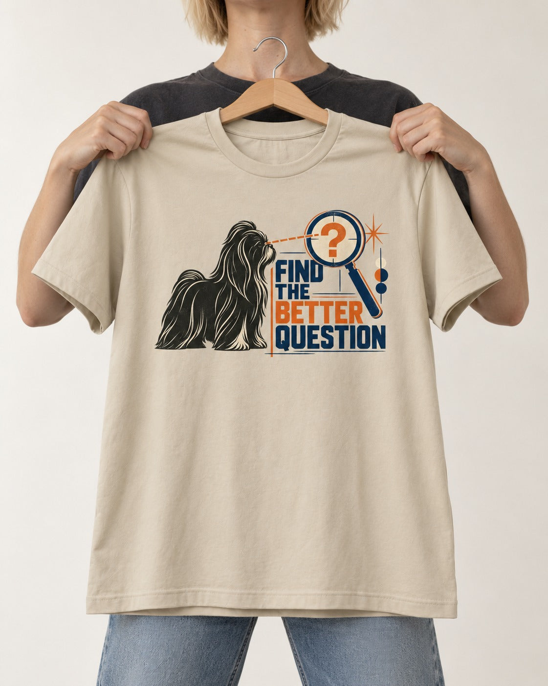 Find the Better Question Shih Tzu T-Shirt in Sand, held up on a hanger