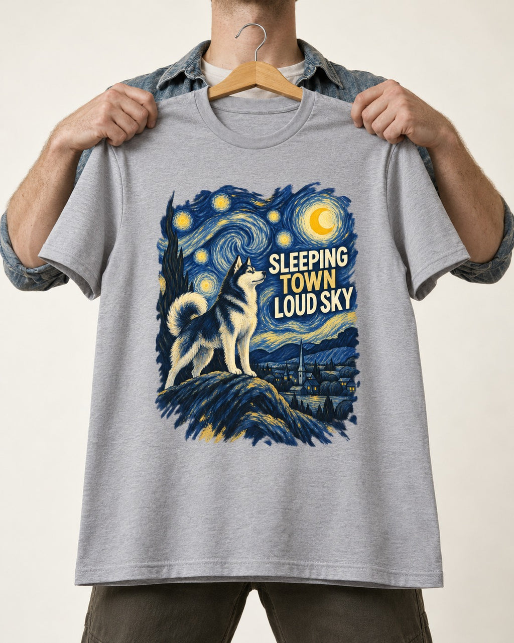 Husky Sleeping Town Loud Sky Starry Night Graphic T-Shirt in Sport Grey, held up on a hanger