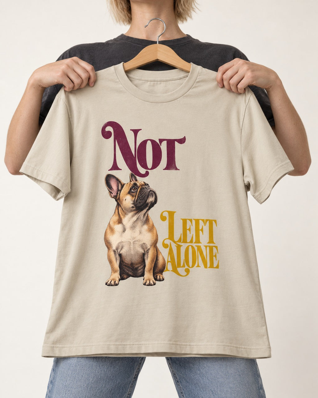 Frenchie Not Left Alone T-Shirt in Sand, held up on a hanger