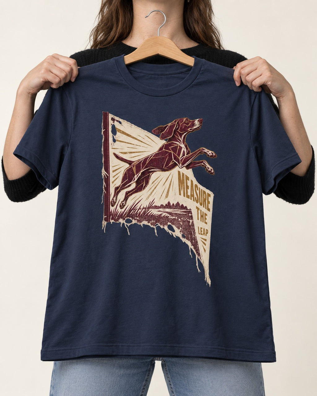 German Shorthaired Pointer Measure the Leap Torn Banner Graphic T-Shirt in Navy, held up on a hanger