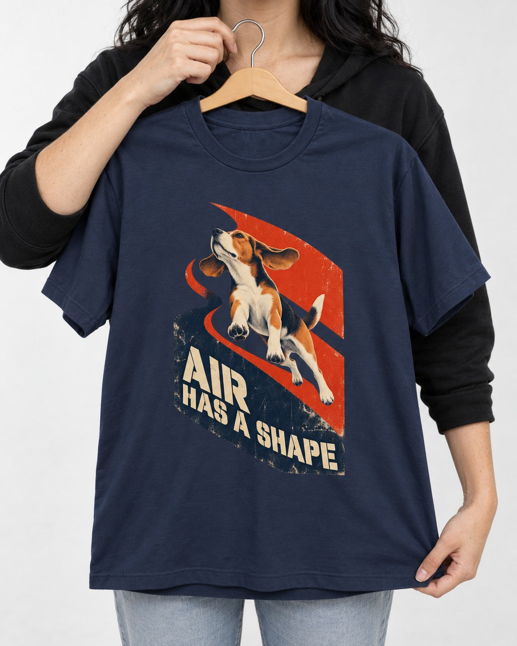 Air Has A Shape Beagle Jumping Graphic T-Shirt in Navy, held up on a hanger