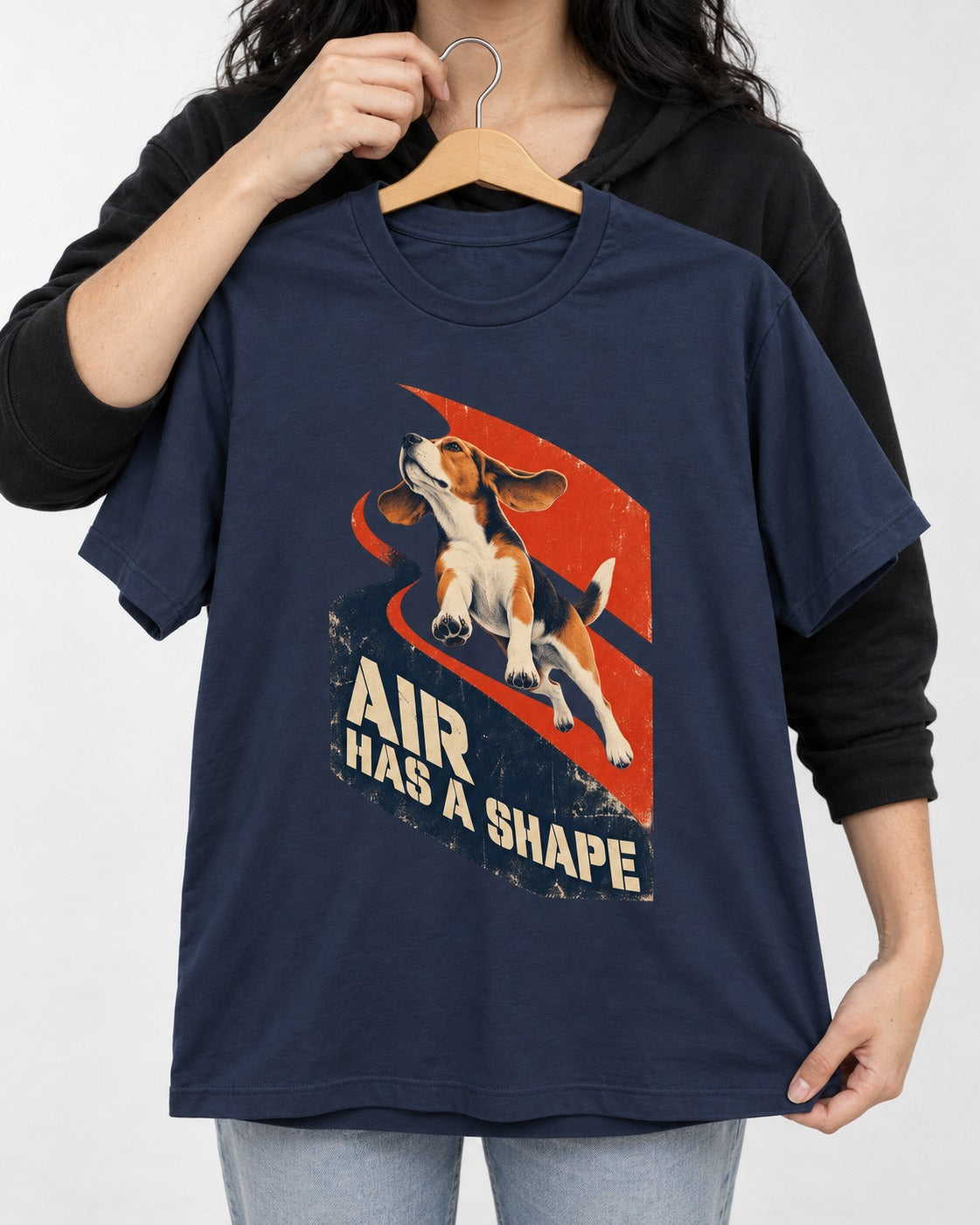 Air Has A Shape Beagle Jumping Graphic T-Shirt in Navy, held up on a hanger