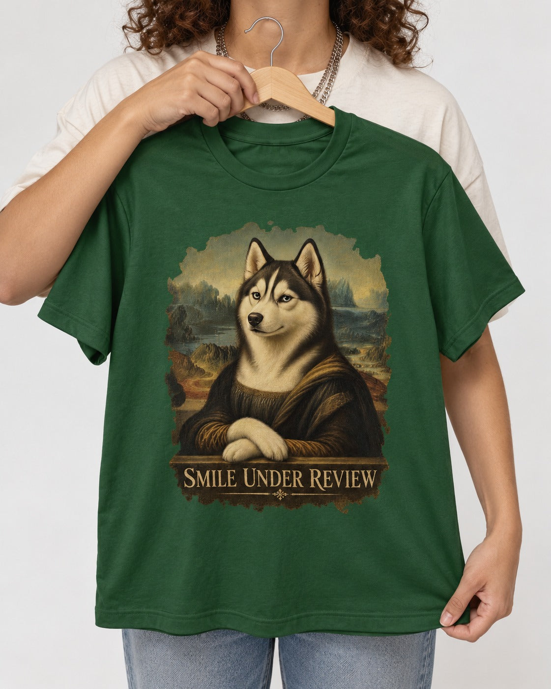Husky Smile Under Review Renaissance Portrait Graphic T-Shirt in Forest Green, held up on a hanger