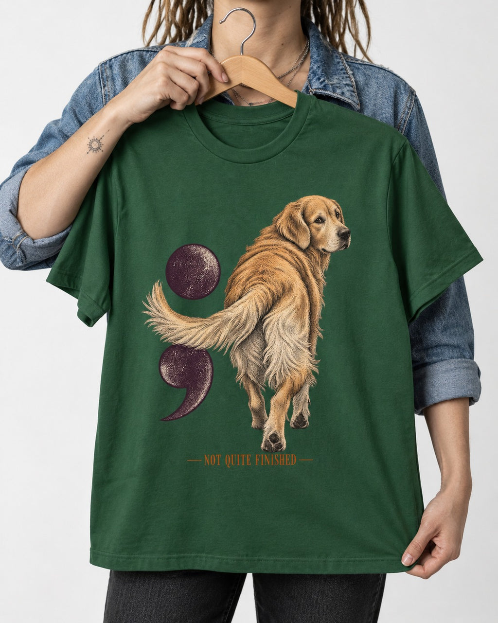 Golden Retriever Not Quite Finished Semicolon Graphic T-Shirt in Forest Green, held up on a hanger