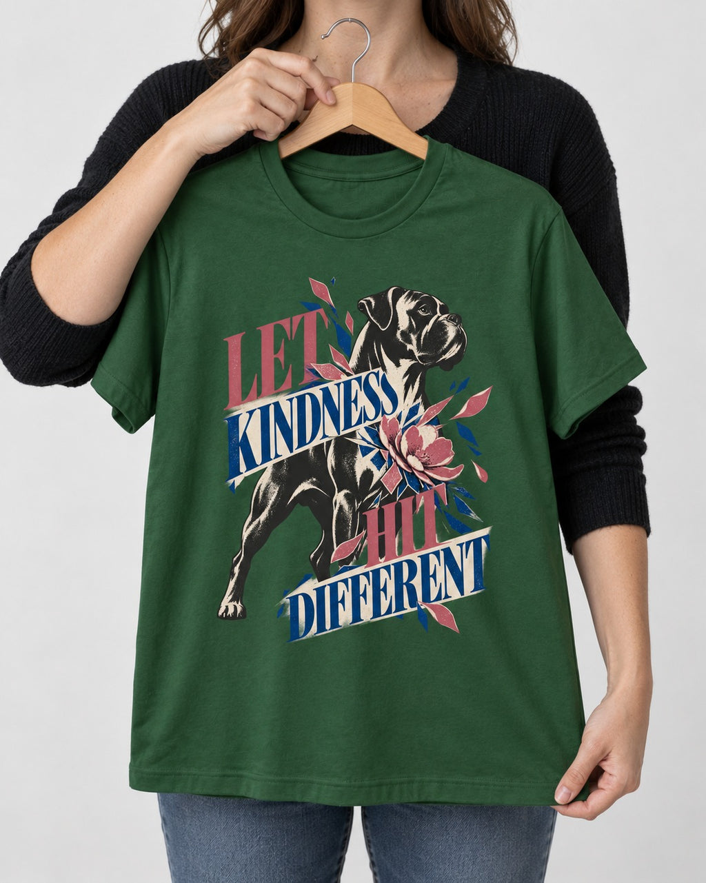 Let Kindness Hit Different Boxer Floral Collage T-Shirt in Forest Green, held up on a hanger