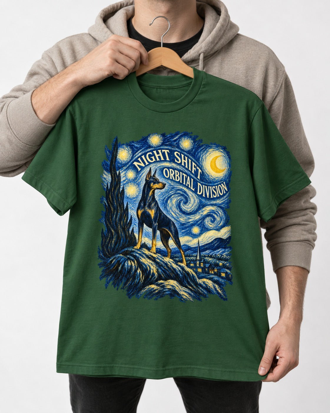 Doberman Night Shift Orbital Division Starry Night Graphic T-Shirt in Forest Green, held up on a hanger