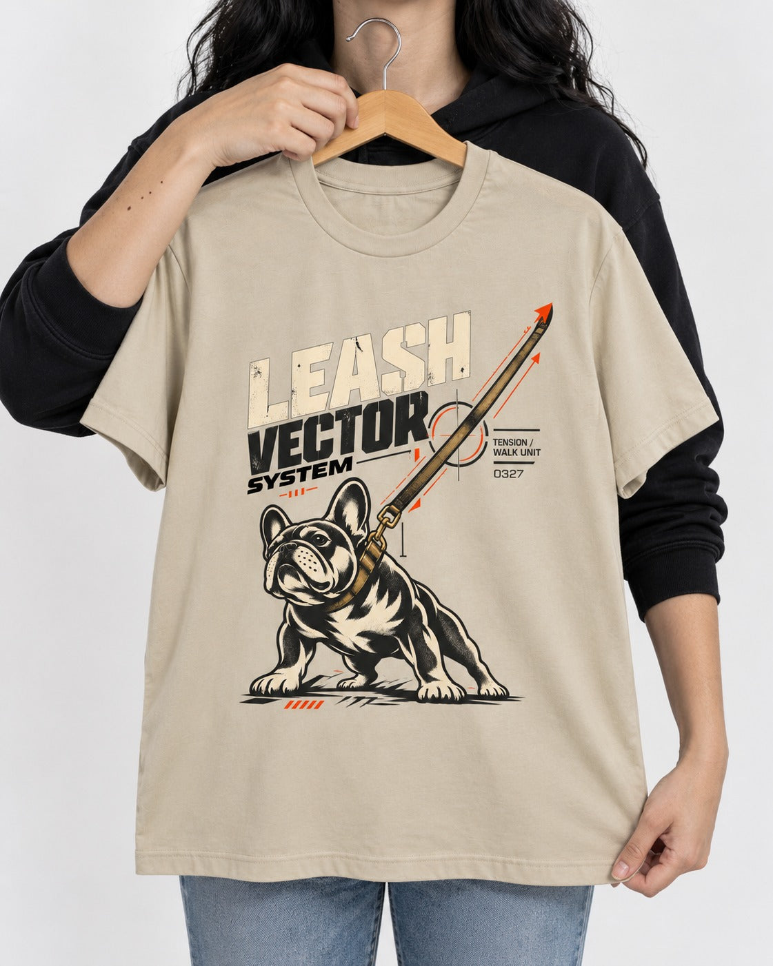 Frenchie Leash Vector T-Shirt in Sand, held up on a hanger